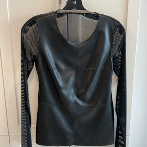 Black top with round sheer neckline & sheer long sleeves.